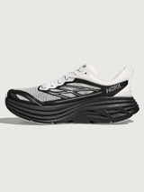 Black and white running shoe with 'Hoka' branding on a light gray background
