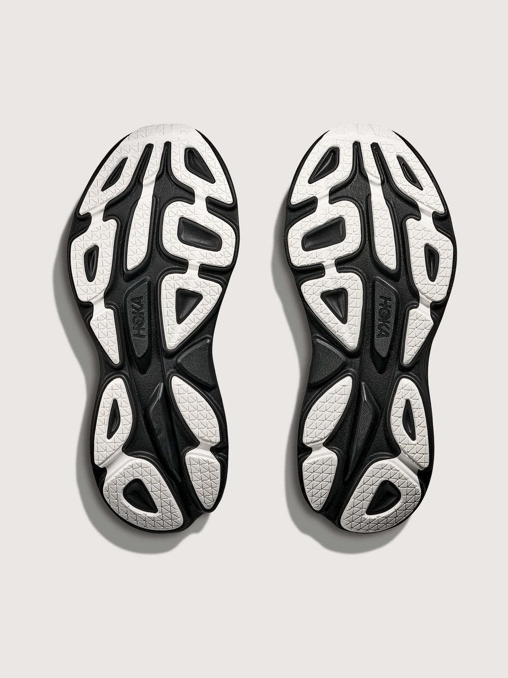 Black and white shoe sole with brand logo on a light gray background