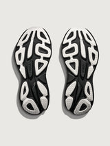 Black and white shoe sole with brand logo on a light gray background