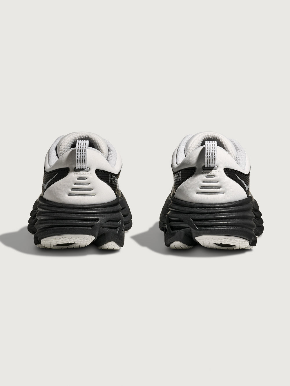 Pair of white and black sneakers on a light gray background