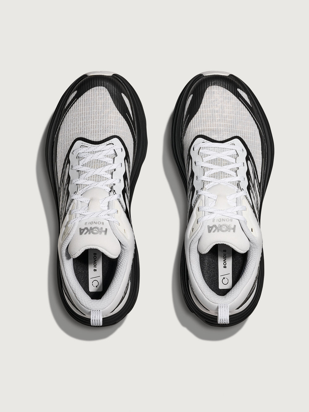 Pair of black and white running shoes on a light gray background