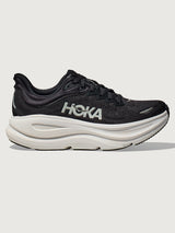 Black running shoe with white sole on a light gray background