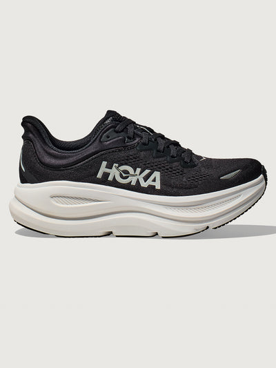 Black running shoe with white sole on a light gray background