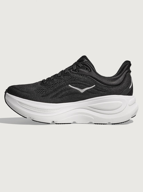 Black running shoe with white sole on a light gray background