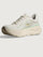 Chunky soled white Hoka running shoe with pastel green trim. 