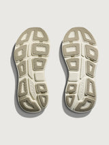 Chunky soled white Hoka running shoe with pastel green trim. 