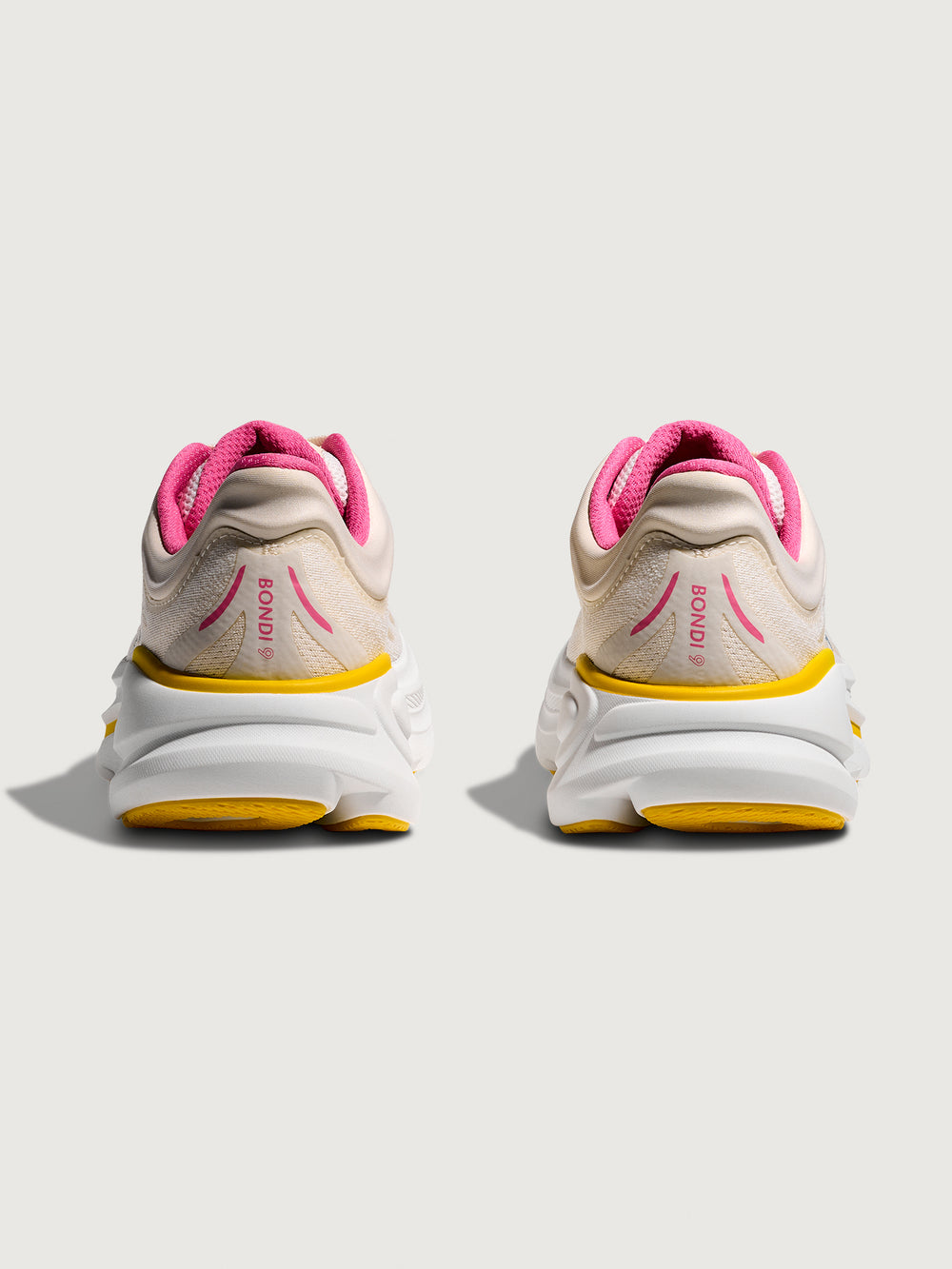 Bondi 9 Max Cushion Running Shoe in Alabaster/Birch, back view highlighting heel counter and branding.