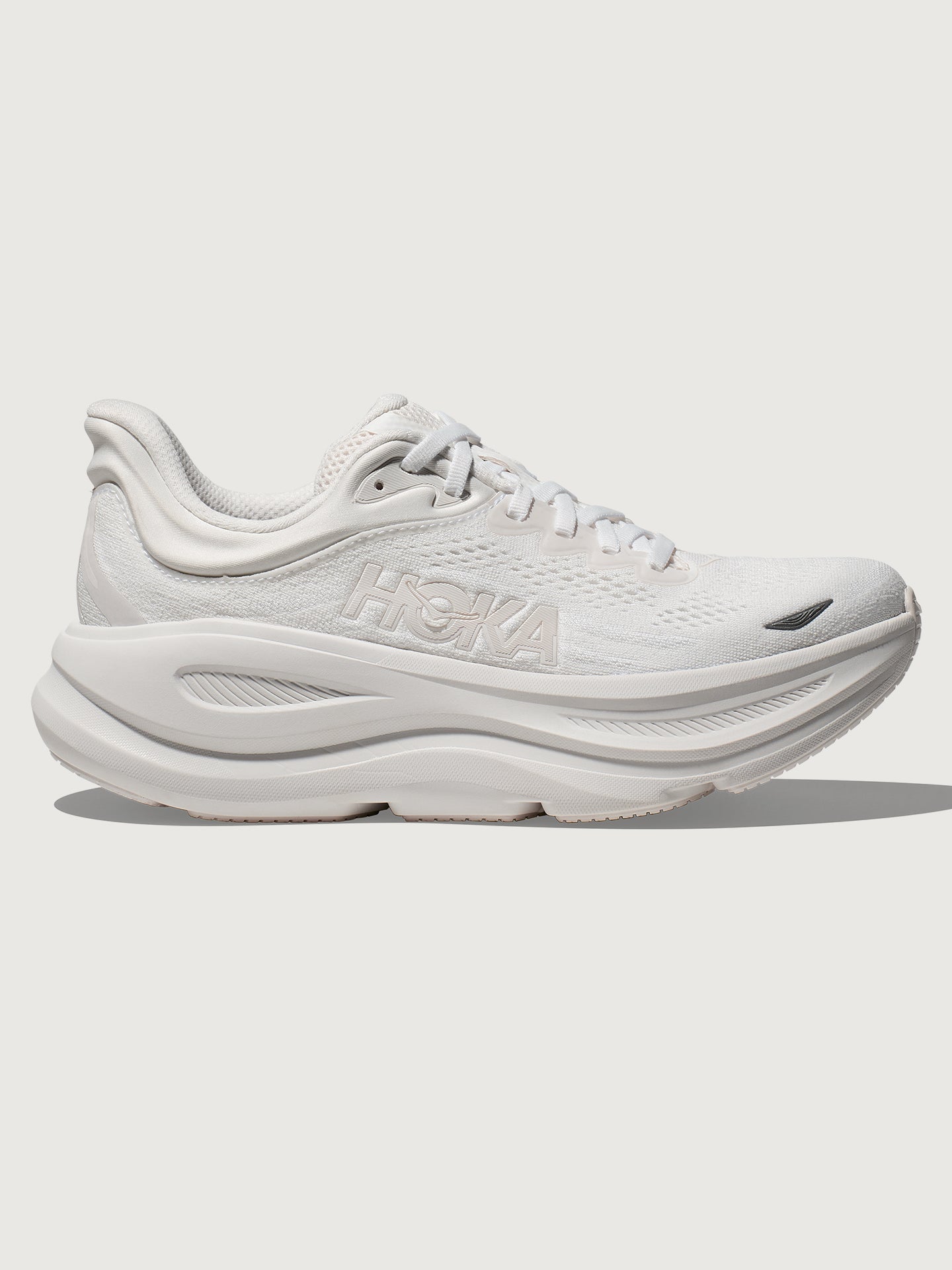 White HOKA Bondi 9 running shoes with a knit upper and cushioned midsole.