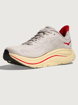 Gray running shoe with red accents with 'Hoka' logo on the side.