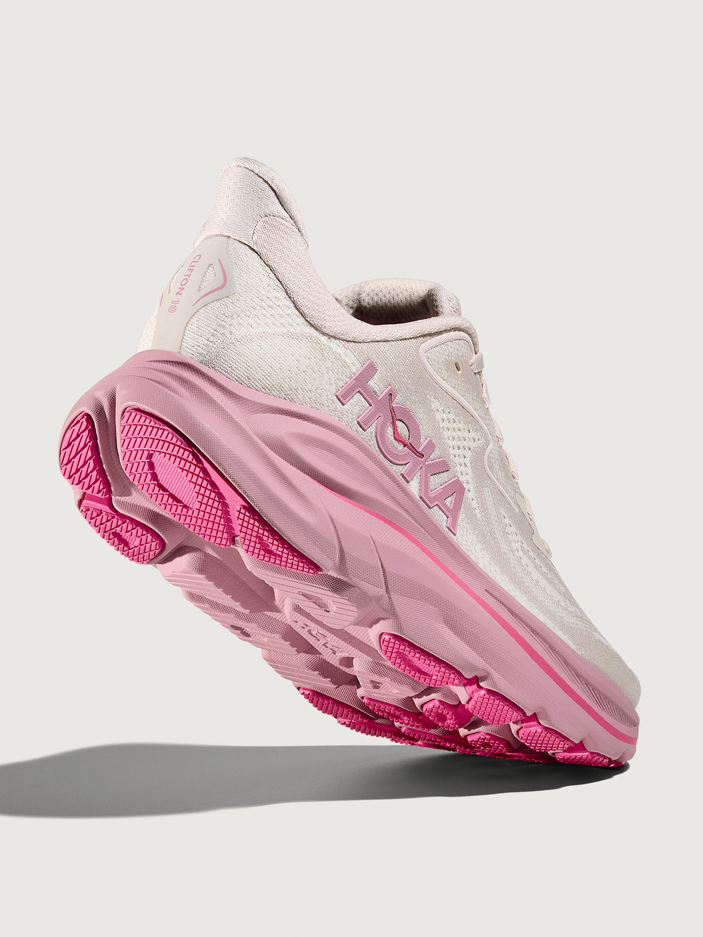 Pink Hoka running shoe with chunky sole.