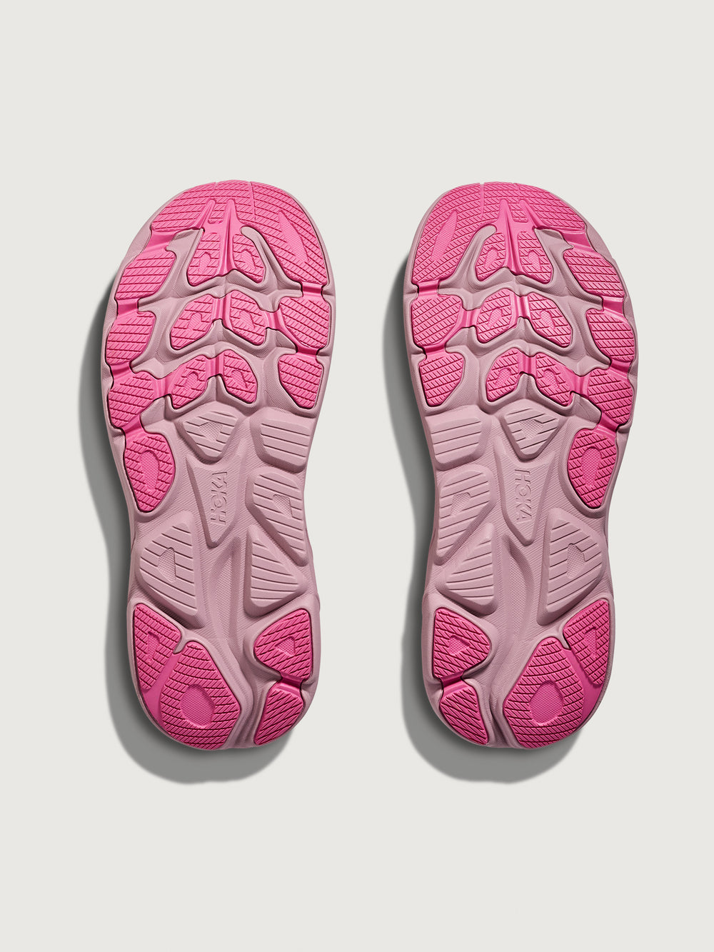 Pink Hoka running shoe with chunky sole.