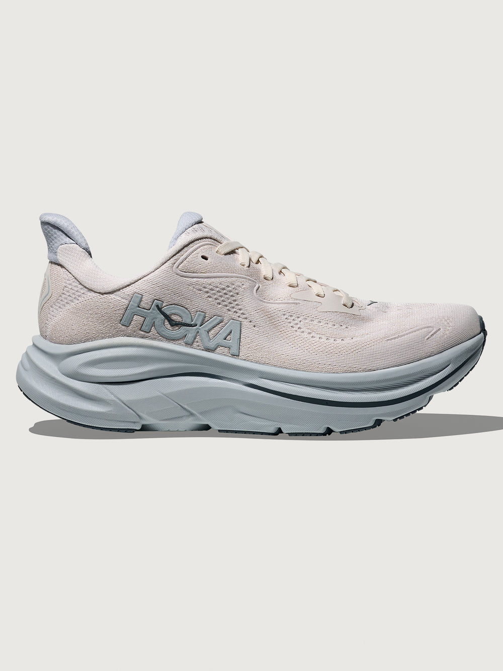 Clifton 10 Max Cushion Running Shoe in Grout/Mineral Blue, side view highlighting cushioned midsole and logo detail.