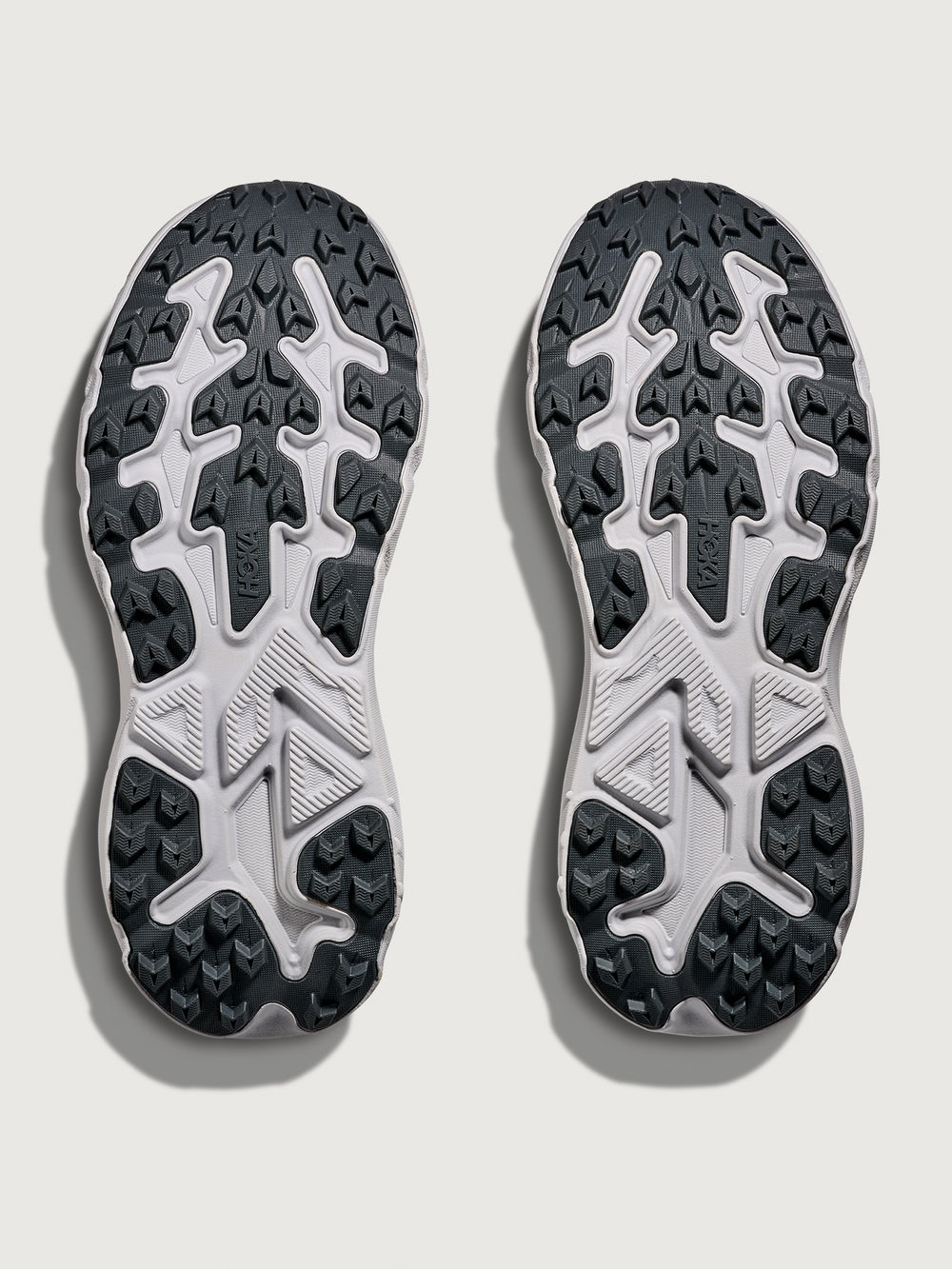 Jade and Grey running shoe with 'Hoka' branding in orange.