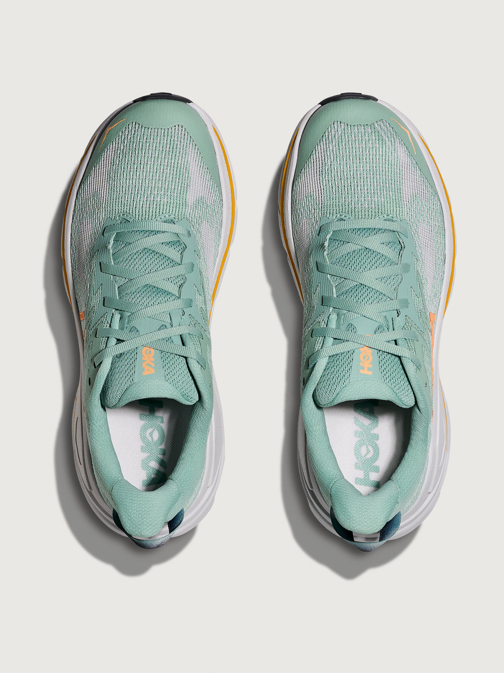 Jade and Grey running shoe with 'Hoka' branding in orange.