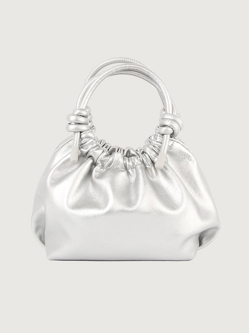 Silver mini handle bag with magnetic closure and knotted detailing on the handles.