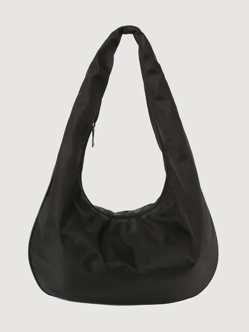 A black matte twill tote bag with a shoulder strap and a zipper outer pocket.