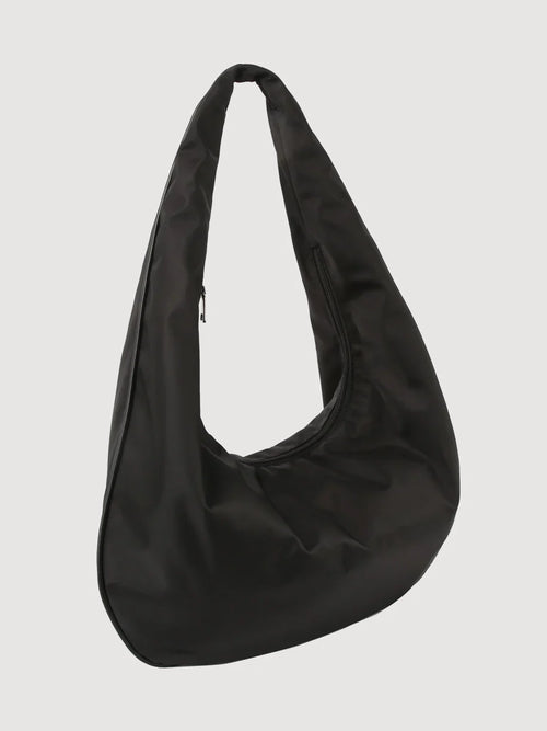 A black matte twill tote bag with a shoulder strap and a zipper outer pocket.