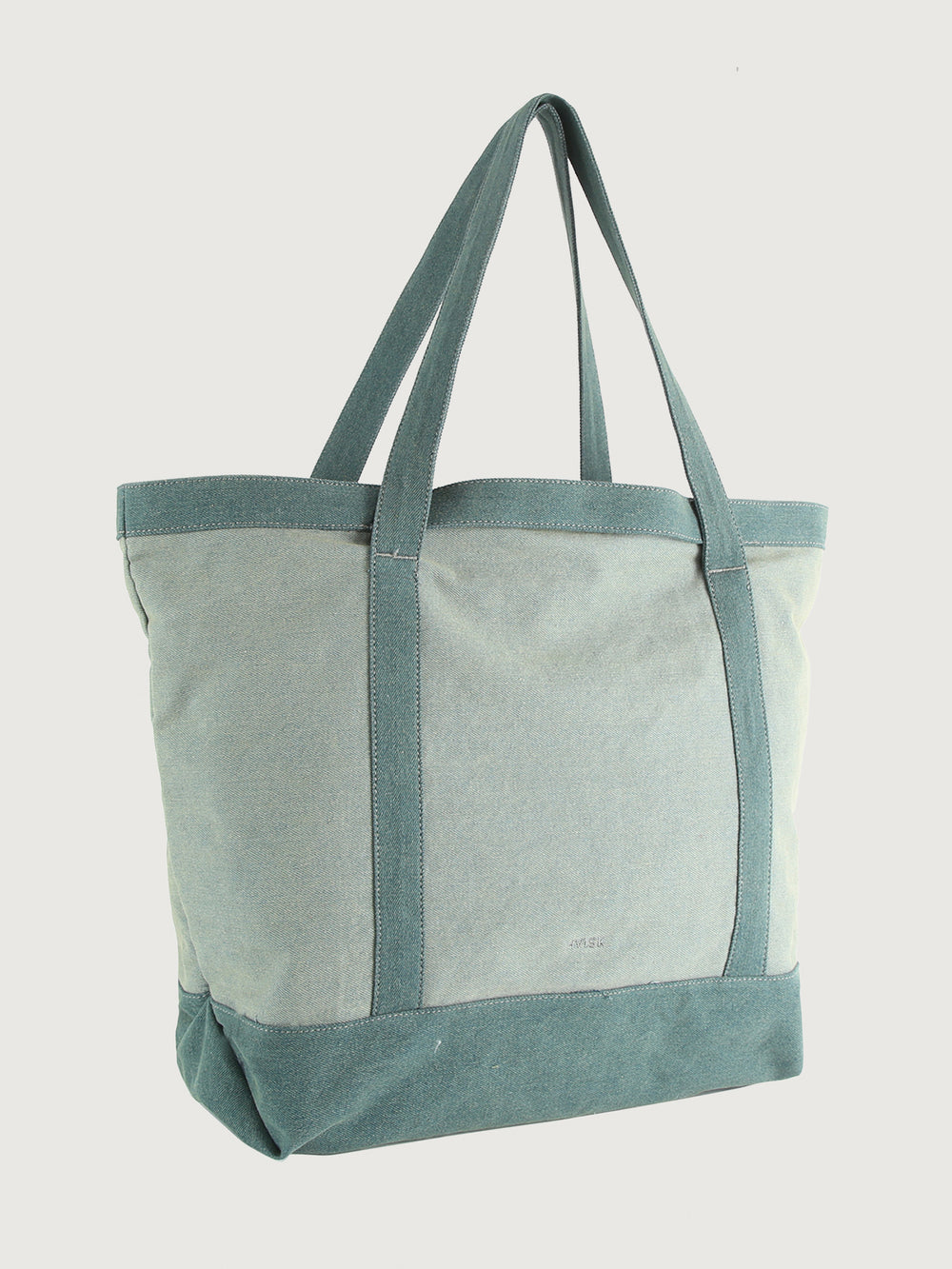 Tote bag with green straps and trim on a light gray background