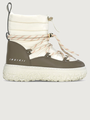White and brown winter boot with Inuikii branding on a light gray background