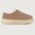 Brown slip-on shoe with white fur lining on a beige background