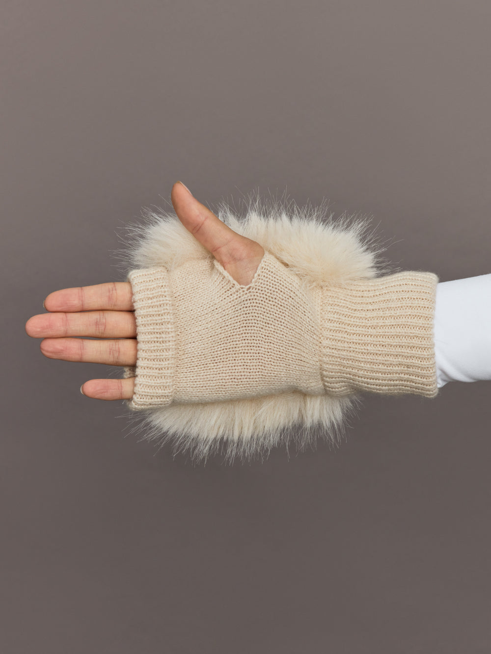 Palm view of beige faux fox knit mitten showing knit detail and open thumb design.