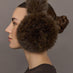 Model is wearing the Faux Fur Earmuffs Chocolate, side profile view.