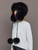 Side view of Fox Trapper Hat in black faux fur with long pom-pom ties.