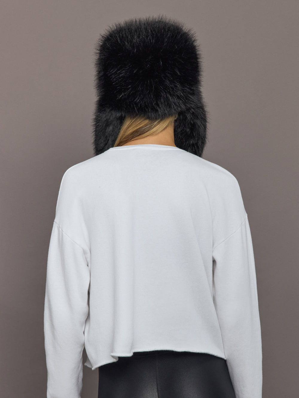 Back view of Fox Trapper Hat in black faux fur showing full coverage.