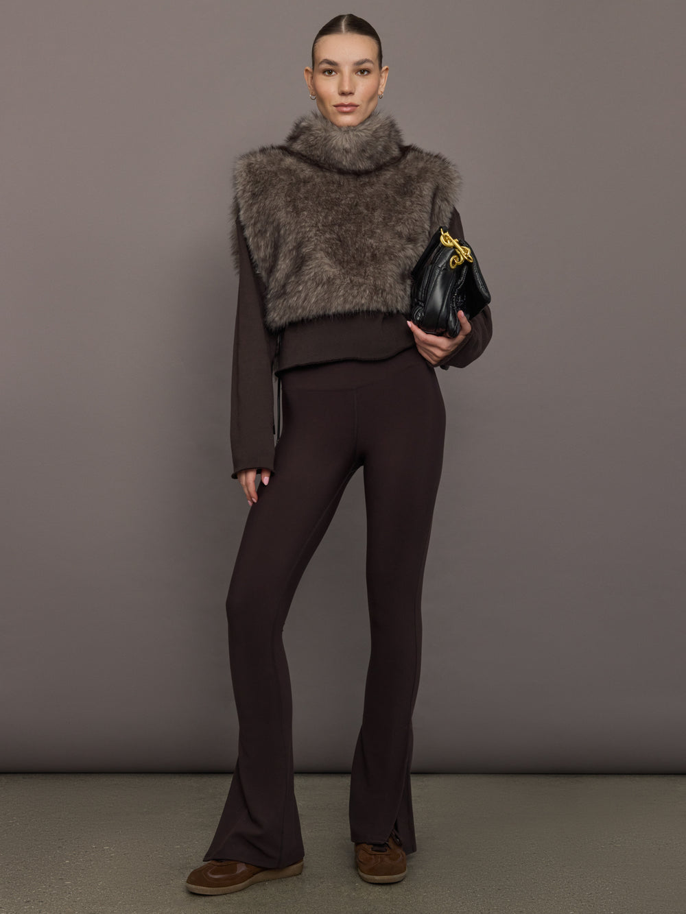 Model is wearing the Faux Fur Pullover Vest with Side Ties Mocha, full body view.