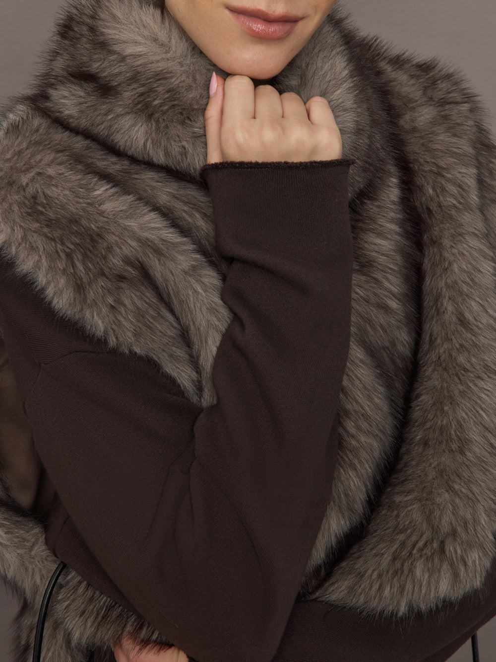 Model is wearing the Faux Fur Pullover Vest with Side Ties Mocha, close up of the faux fur texture.