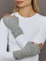 Model wearing light grey ribbed fingerless knit gloves with embroidered heart, front view.