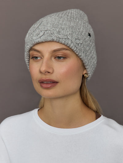 Model wearing Love embroidered knit hat in light grey, front view.