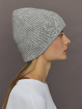 Left side profile of Love embroidered knit hat in light grey showing ribbed texture.