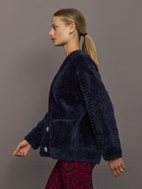Side profile of model in navy faux fur cardigan highlighting relaxed fit.