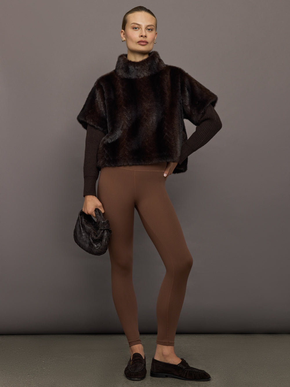 Full outfit view of dark brown faux fur pullover sweatshirt styled with brown ribbed leggings and loafers.