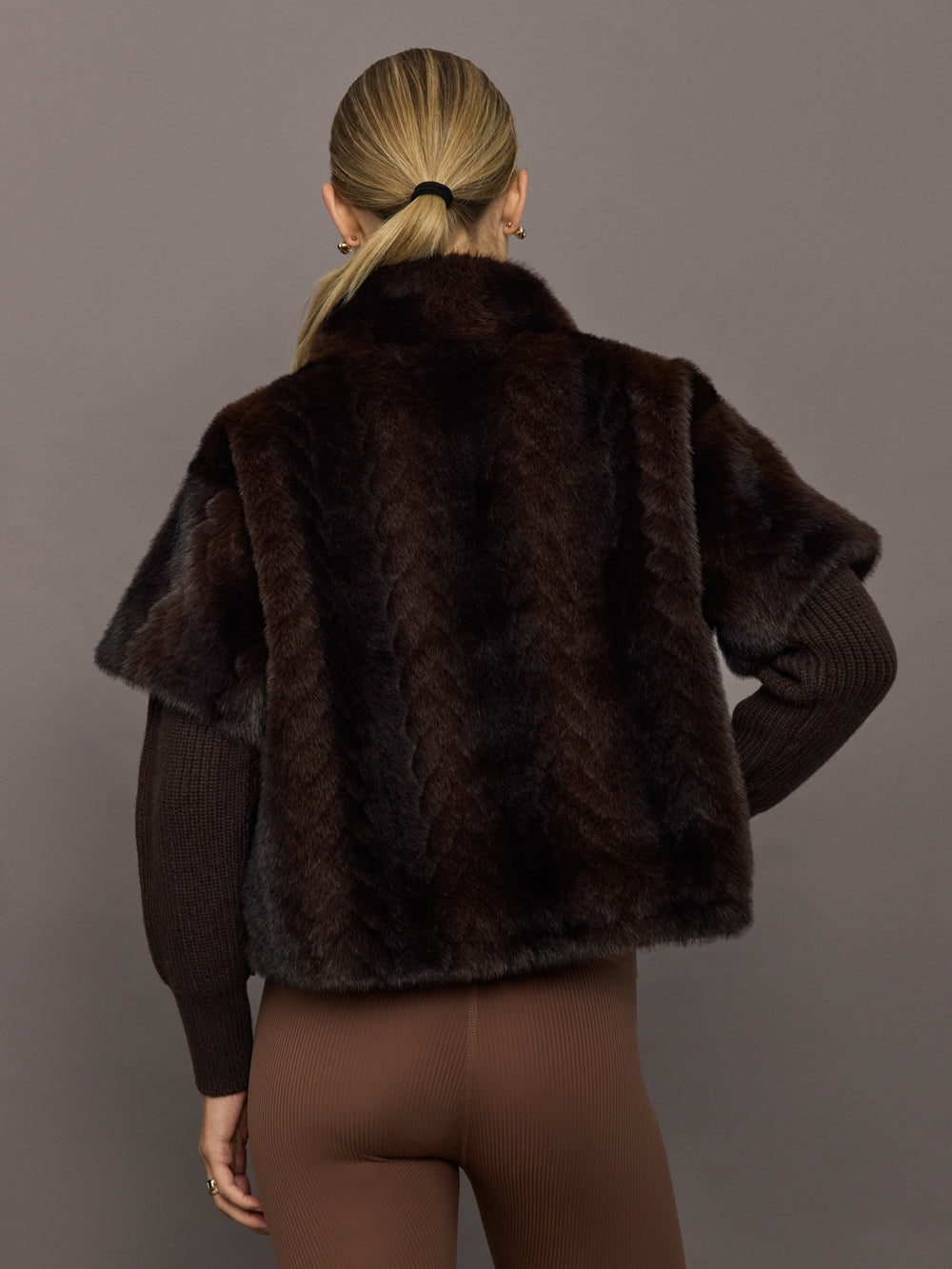 Back view of dark brown faux fur pullover sweatshirt with high collar.