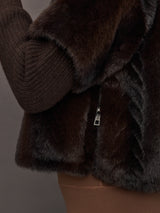 Close-up of side zipper detail on dark brown faux fur pullover sweatshirt.