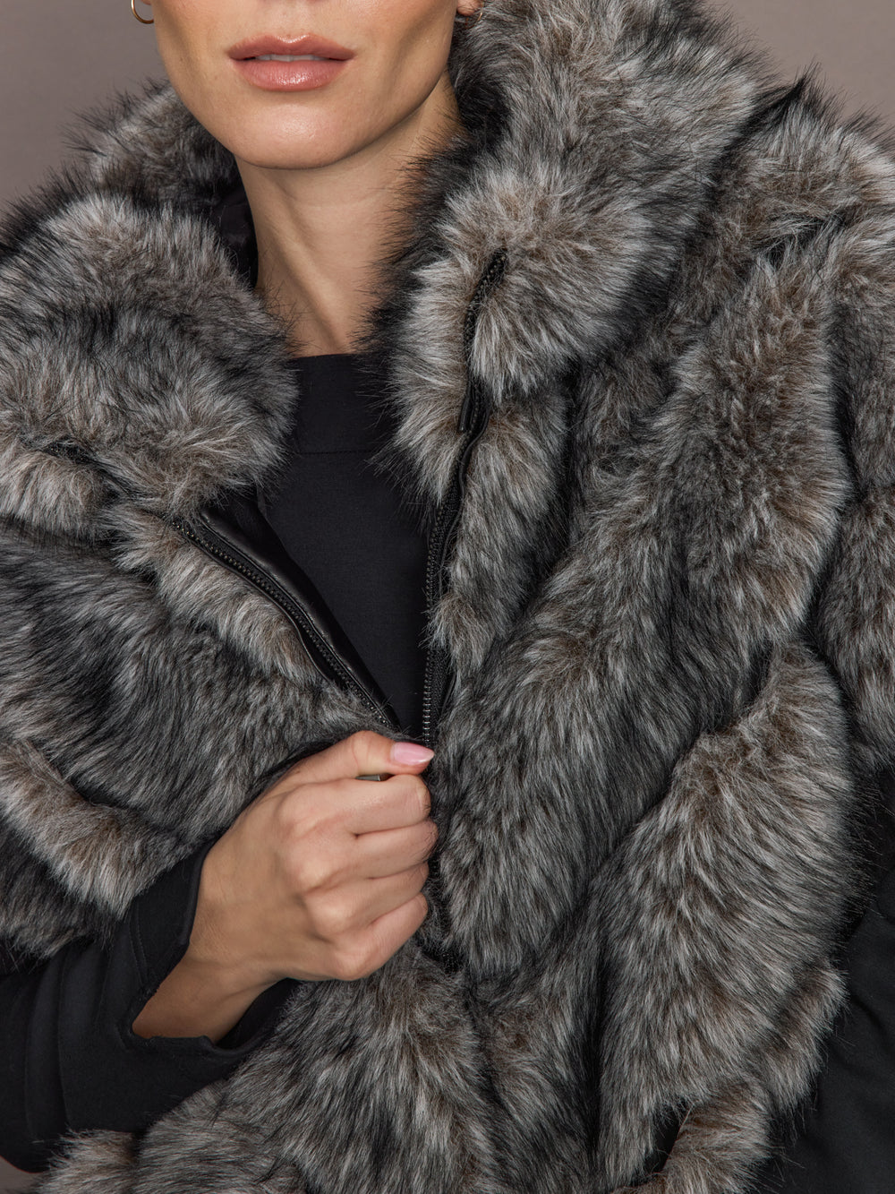 Close up of Faux Fox Hooded Chevron Short Sleeve Jacket in grey showing zipper and faux fur texture.