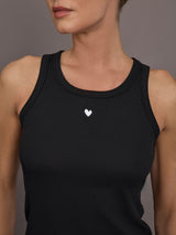 Model is wearing KR Ribbed Performance Tank in black, close-up neckline detail.