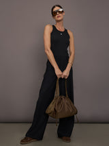 Model is wearing KR Ribbed Performance Tank in black, full body view.