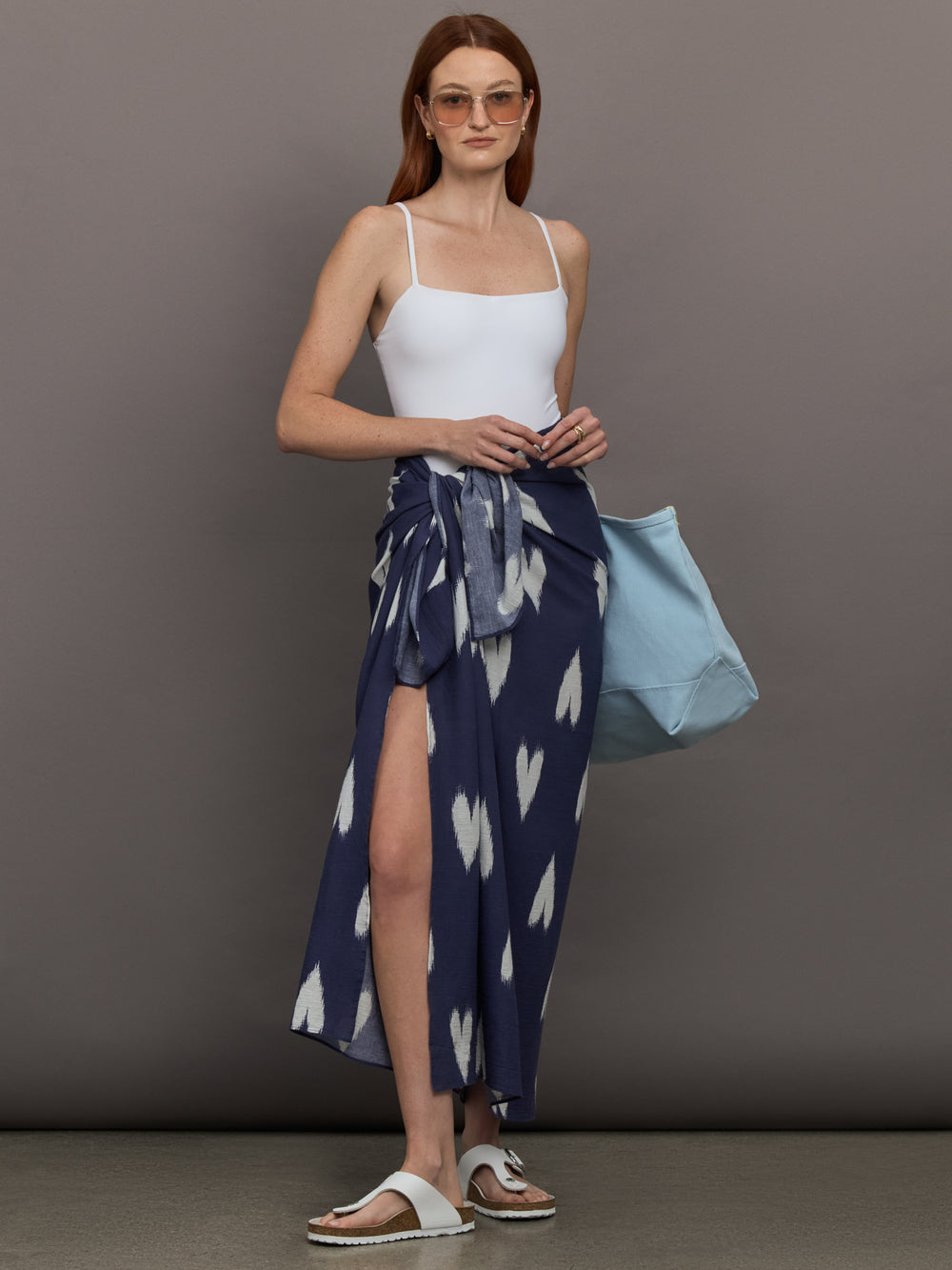 Model wears Indigo-colored sarong featuring a white heart pattern.