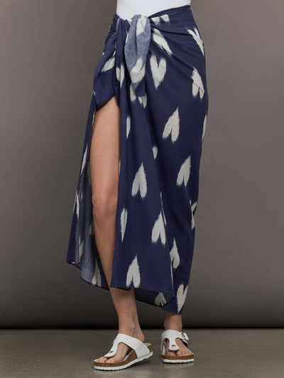 Model wears Indigo-colored sarong featuring a white heart pattern.