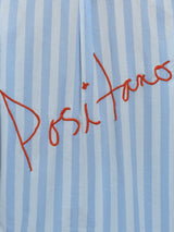 Model wears a striped blue and white buttondown long sleeve with single chest pocket. 