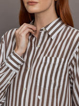 Model wears brown and white striped button-down shirt with a relaxed fit, long sleeves.