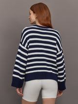 Model wears sweater in indigo and white featuring an abstract, imperfect heart design on the front, with long sleeves and a relaxed fit.