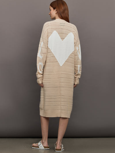 Model wears long, lightweight duster-style sweater in a natural beige tone.