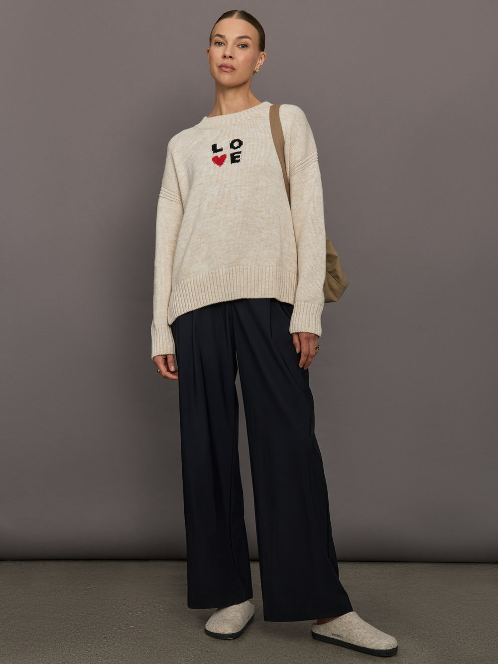 Beige sweater with 'LOVE' text and red heart design.