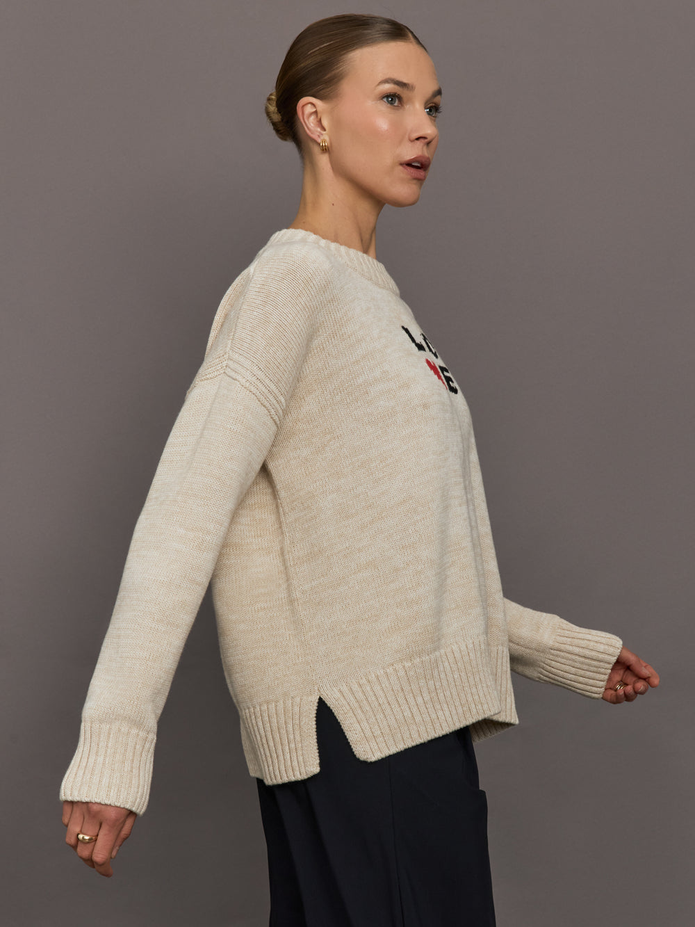Beige sweater with 'LOVE' text and red heart design.