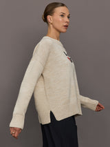 Beige sweater with 'LOVE' text and red heart design.