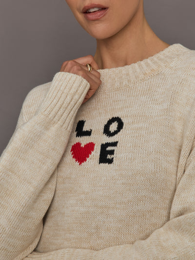 Beige sweater with 'LOVE' text and red heart design.